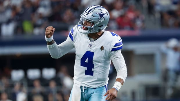 Dak Prescott pumps his fist after throwing a touchdown pass.